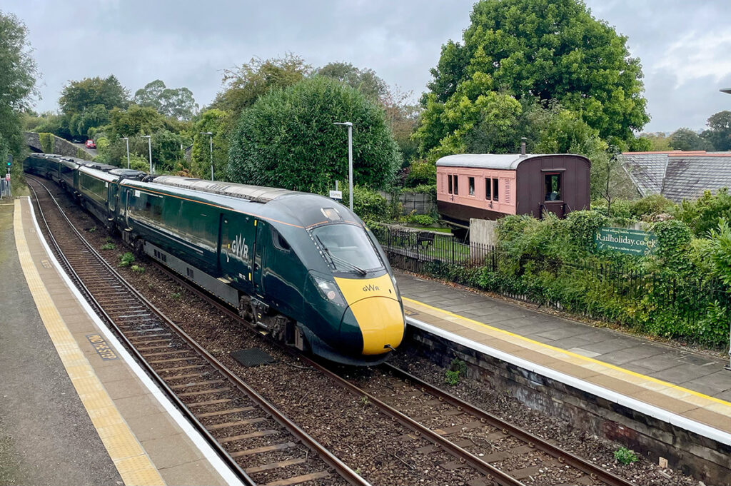 Let the train take the strain! A London train slowly comes into the station outside the Old Luggage Van